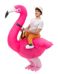 Person riding an inflatable pink flamingo costume on a white background