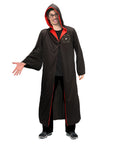 Person wearing a black hooded robe with red trim on a white background