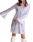 Woman wearing a silver 70s disco dress with long sleeves on a white background