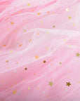 Close up of a pink tulle cape fabric with star-shaped glitter embellishments