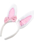White bunny ears with pink sequin bow on a white background