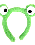 A bright green fuzzy frog headband with large cartoon eyes on a plain white background.