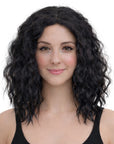 Woman with black wavy hair wearing a black tank top on a white background