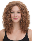 Woman with curly brown hair wearing a black tank top on a white background