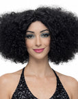 Woman wearing a black curly wig on a white background