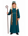 A child wearing a long dark teal costume dress with cream hood details and brown-and-gold striped side panels, holding a wooden staff against a plain white background.
