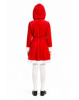 A child shown from the back wearing a red hooded dress or costume with white trim at the cuffs and hem, paired with white tights and black shoes, on a plain white studio background.