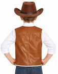 A child shown from the back wearing a brown cowboy hat, a brown faux-leather vest, a white collared shirt, and blue jeans against a plain white background.