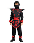Child wearing a black and red ninja costume on a white background