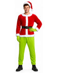 a man wearing a red Santa hat and Santa jacket with green pants and green pointed gloves; a Grinch inspired Christmas costume dress up.