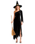 a woman wearing a black, one shoulder witch dress and witch hat, holding a witch broom. 