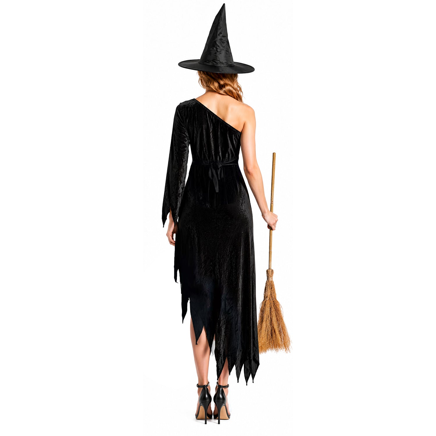 the back of a woman wearing a black, one shoulder witch dress and witch hat, holding a witch broom. 