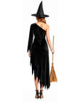 the back of a woman wearing a black, one shoulder witch dress and witch hat, holding a witch broom. 