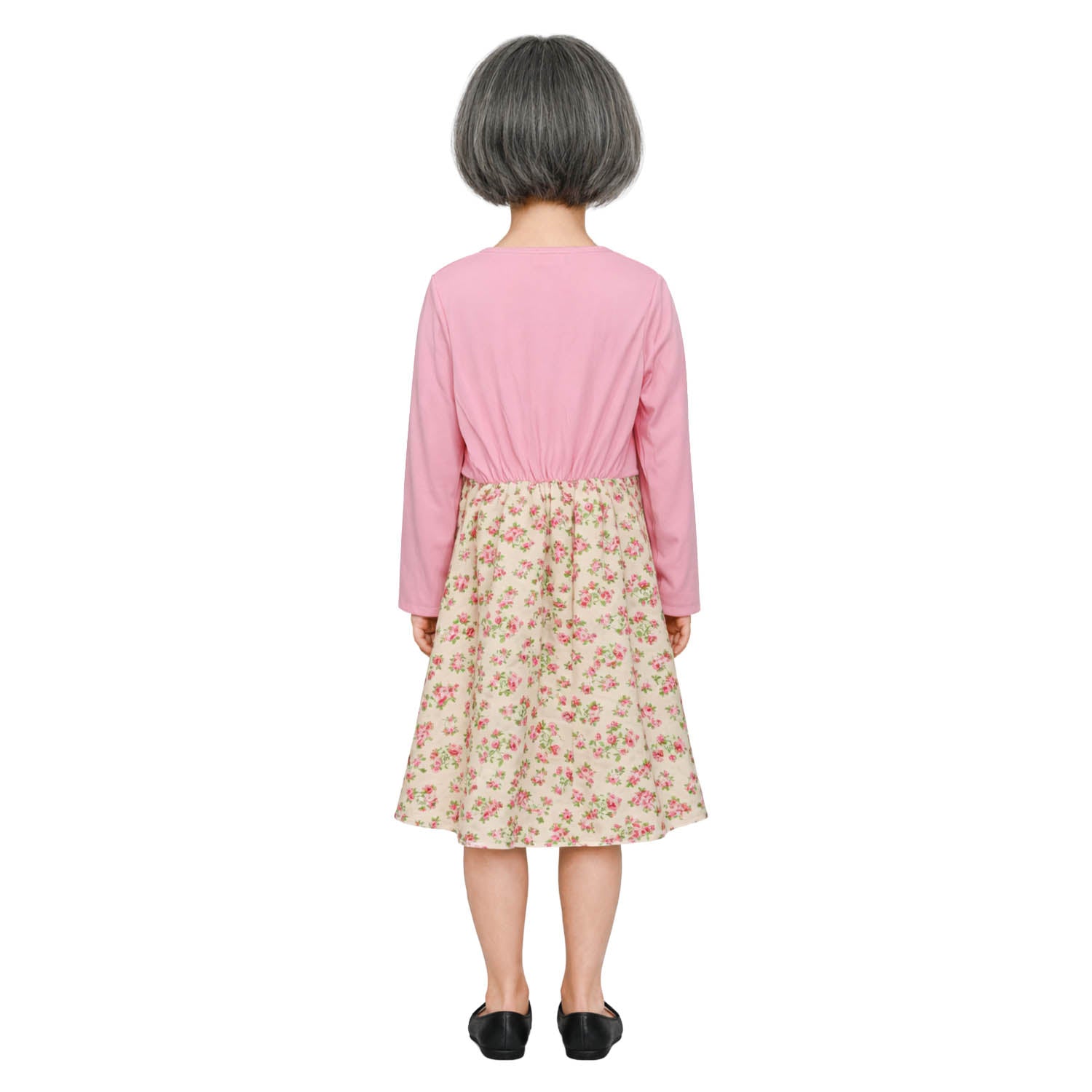Person wearing a pink top and floral skirt on a white background