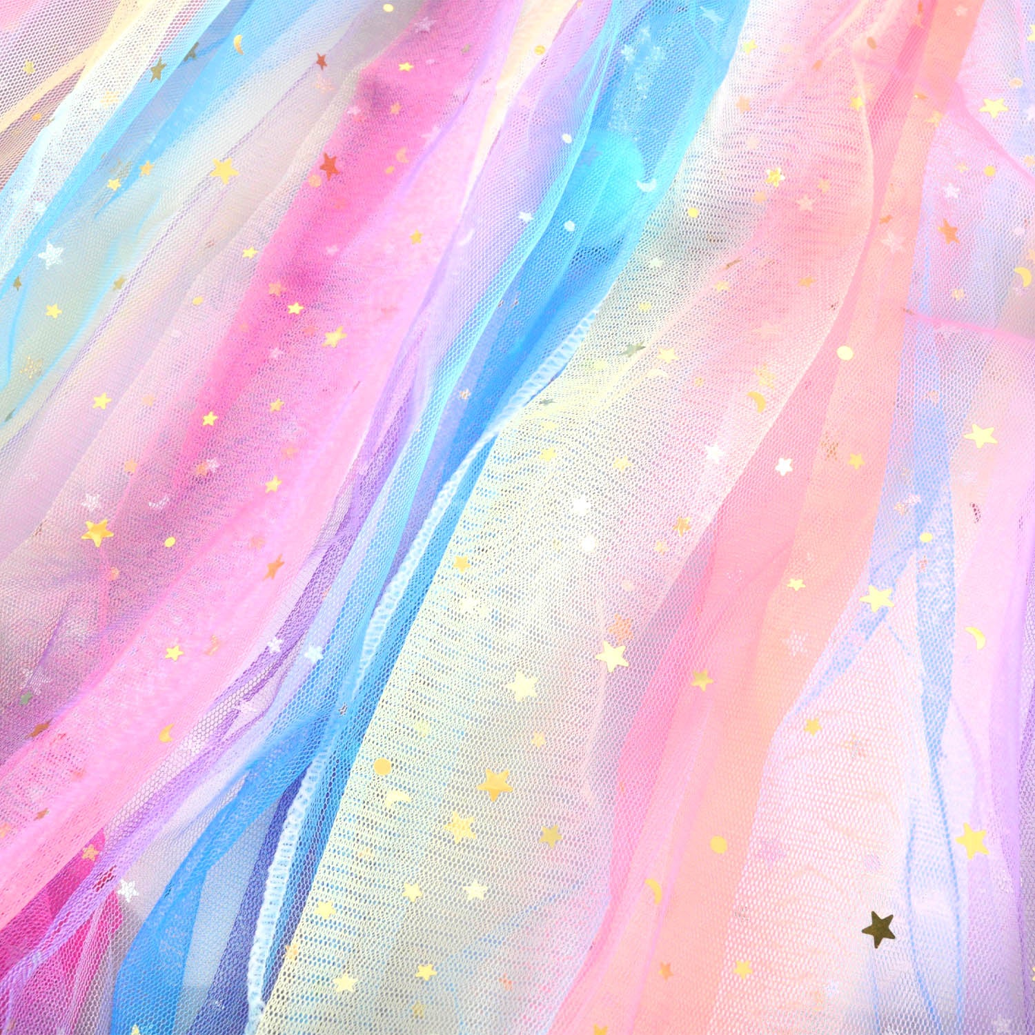 Multicolored tulle fabric with star-shaped sequins on a soft focus background