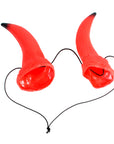 A pair of red devil horn-shaped accessories with black tips and black elastic cords, arranged in a heart shape on a plain white background.