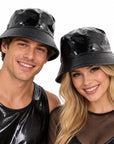a man and a woman wearing metallic black bucket hats.