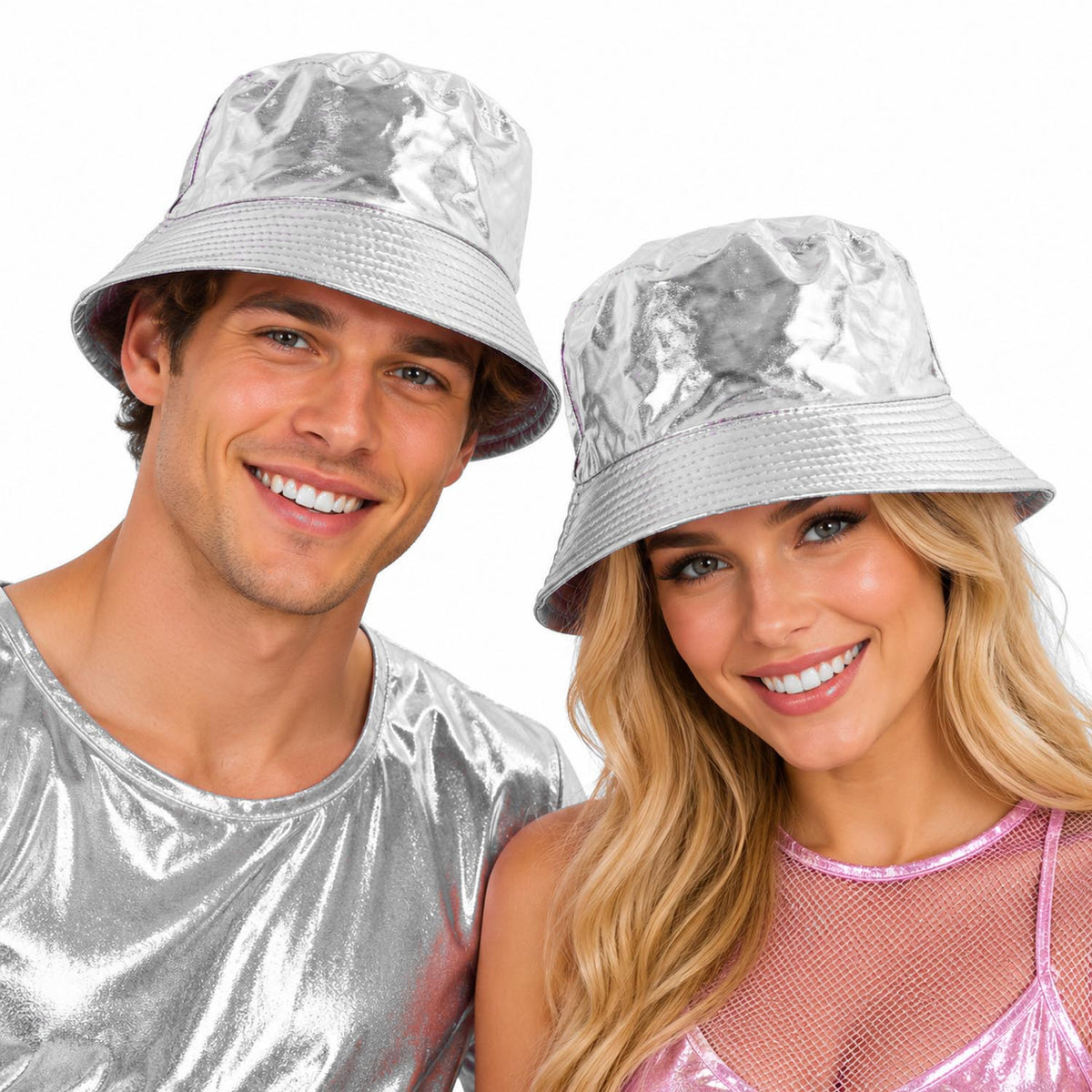 A man and a woman wearing shiny silver bucket hats and matching metallic silver tops, smiling against a plain white background.