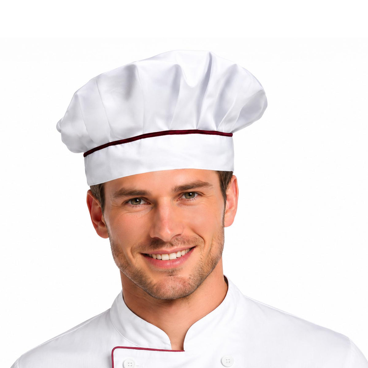 A smiling man wearing a white chef's hat with a thin dark red band and a white chef jacket with matching red piping, photographed against a plain white background.
