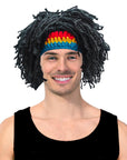Person wearing a colorful headband and black wig on a white background