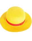 Yellow straw hat with a red band on a white background