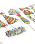 A set of colorful birthday photo booth props on wooden sticks, including a 'HAPPY BIRTHDAY' banner, party hats, striped ties, balloons, candles, gifts, and a cake, arranged on a white background.