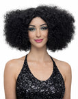 Woman wearing a black curly wig on a white background