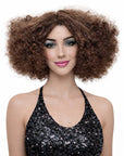 Woman with large afro hairstyle wearing a black sequin top on a white background