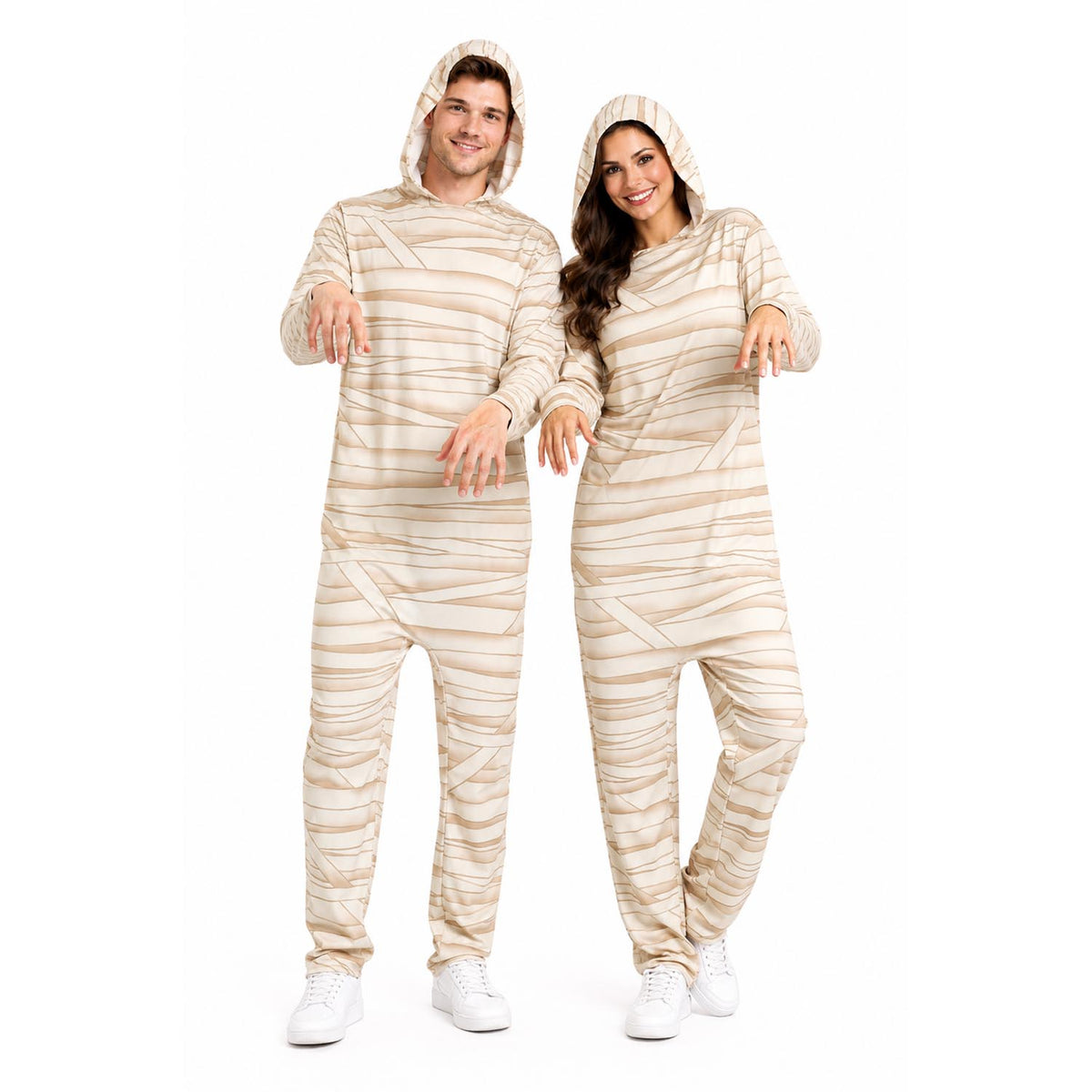 A man and a woman modelling matching hooded one-piece jumpsuit with beige and white horizontal stripes like bandages, posed against a plain white studio background.