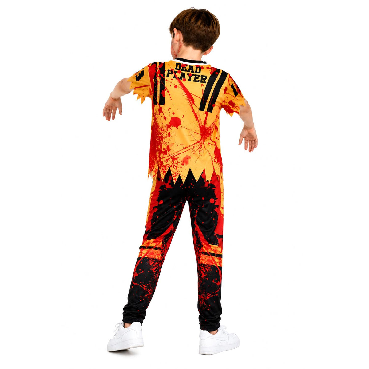 A child model shown from the back wearing a zombie-style one-piece costume with a tattered yellow, orange, and red print, black text reading 'DEAD PLAYER' on the back, and black-and-red distressed graphics on the pants, against a plain white background.