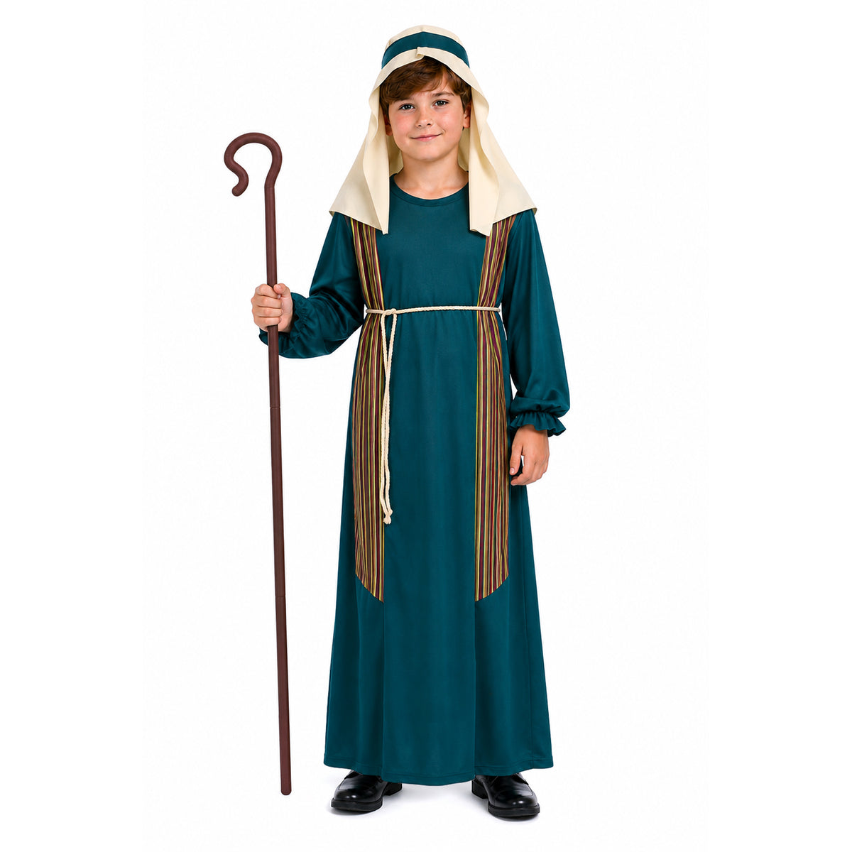 A child wearing a long dark teal costume dress with cream hood details and brown-and-gold striped side panels, holding a wooden staff against a plain white background.