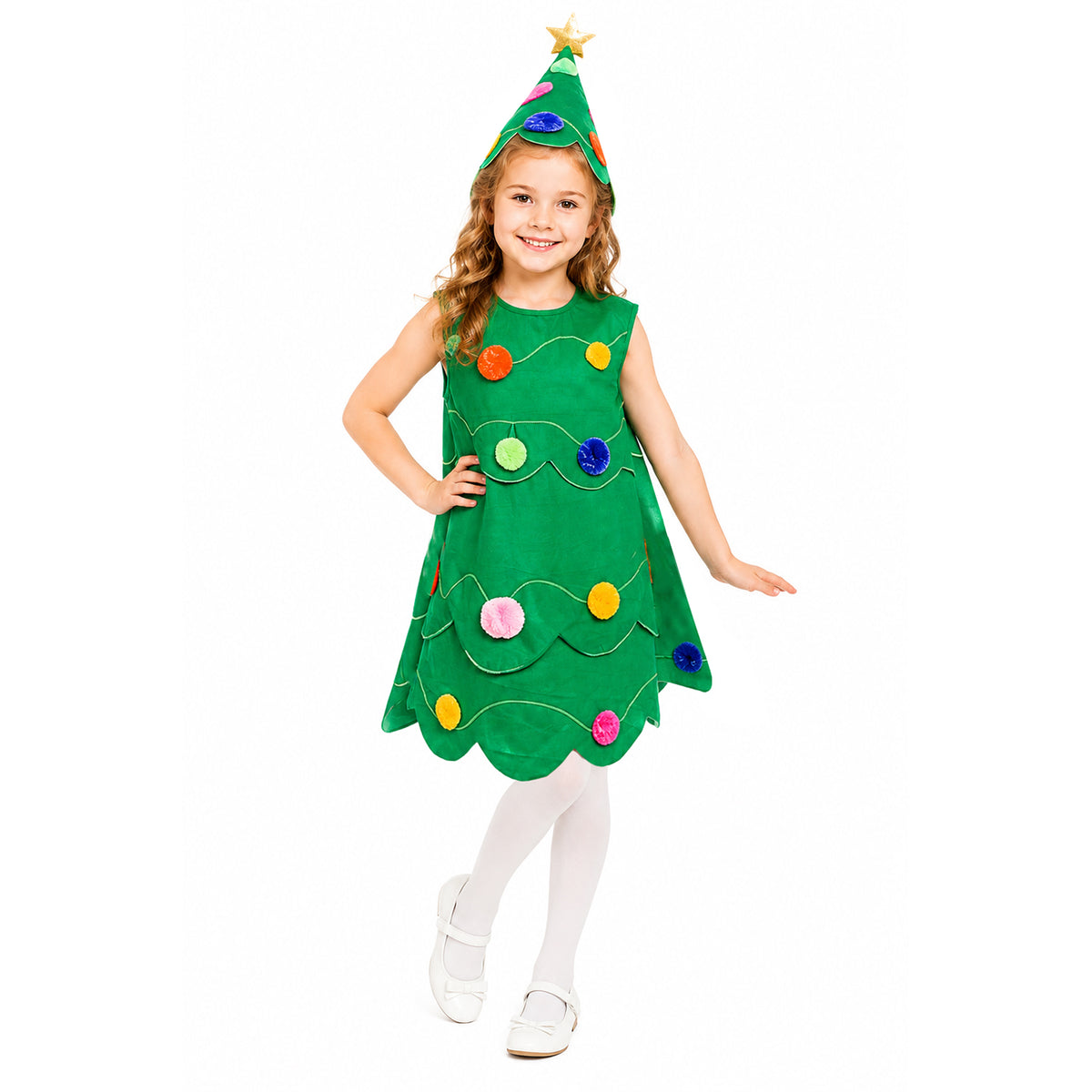 A young girl modeling a green Christmas tree costume dress with colorful felt ornaments and a matching pointed green hat with a star topper, photographed against a plain white background.