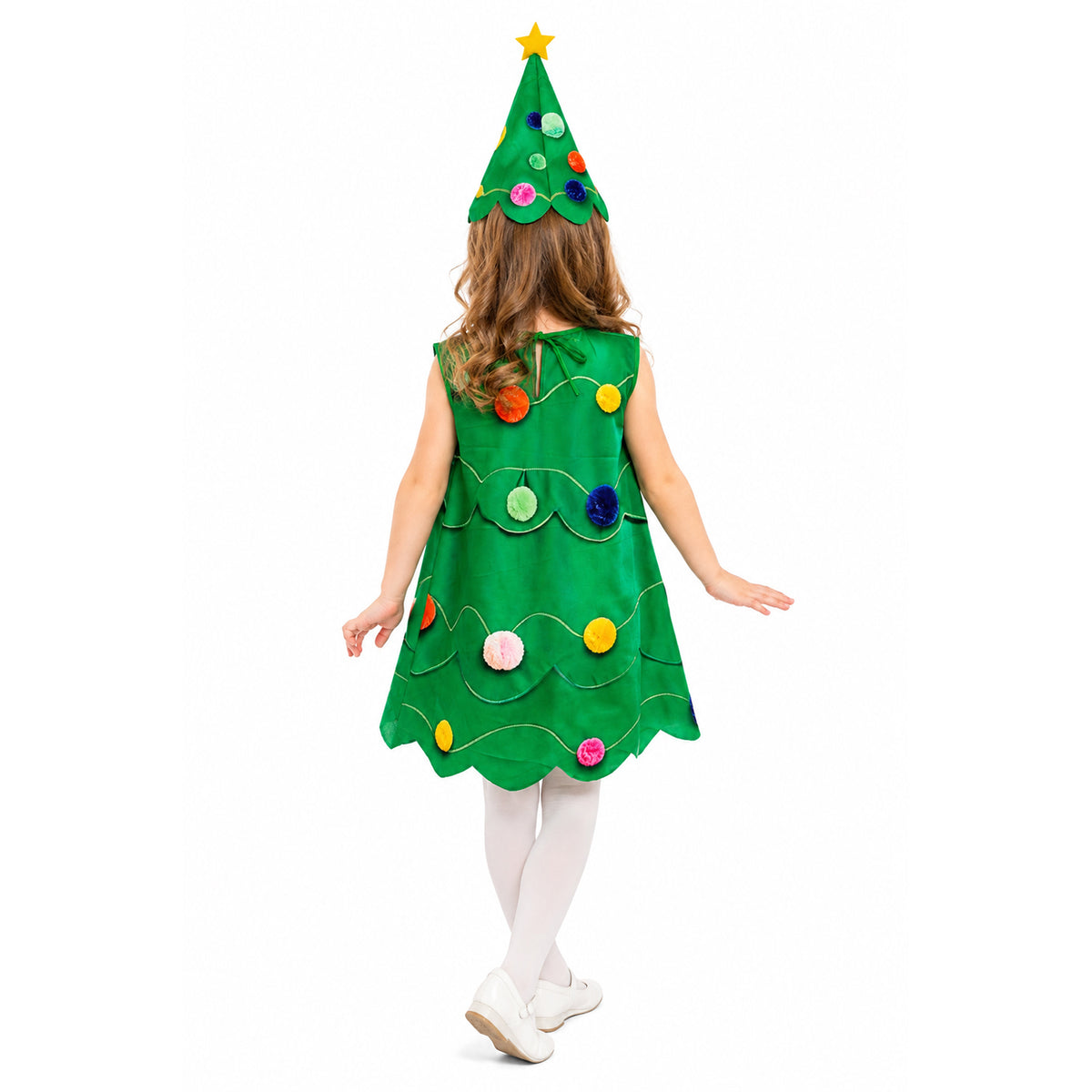 A child viewed from behind wearing a green Christmas tree costume with colorful felt ornaments and a matching pointed hat topped with a yellow star, on a plain white background.