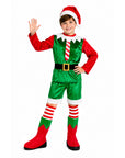A child modeling a Christmas elf costume consisting of a green velvet vest and shorts with red sleeves, a red and white striped tie, a black belt with a gold buckle, red and green striped socks, red boots, and a Santa hat, set against a plain white background.