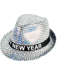 A silver holographic fedora hat featuring a black band with the text 'HAPPY NEW YEAR' in white capital letters, set against a plain white background.